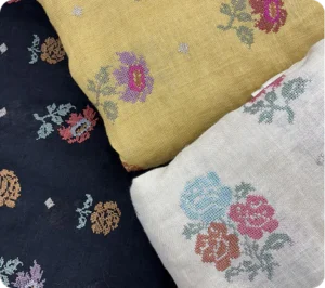 Cream-colored base with thick floral multicolored embroidery fabric using silk threads